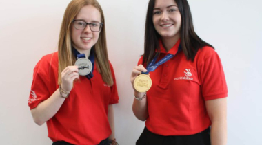 two female students with medals