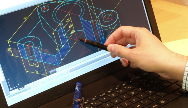 Photo of a CAD Technician pointing at a drawing on a computer screen