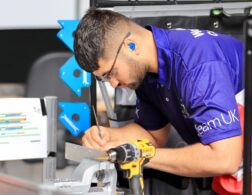 Photo of Isaac competing internationally in the Manufacturing Team Challenge