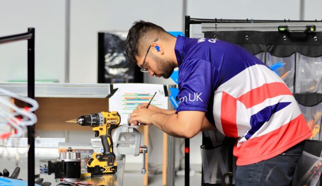 Photo of Isaac competing internationally in the Manufacturing Team Challenge