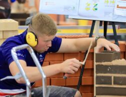Photo of Lewis competing internationally in the bricklaying competition