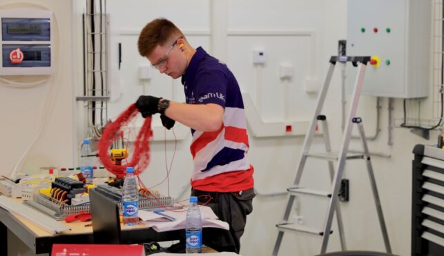 Photo of Thomas competing internationally in the electrical installation competition